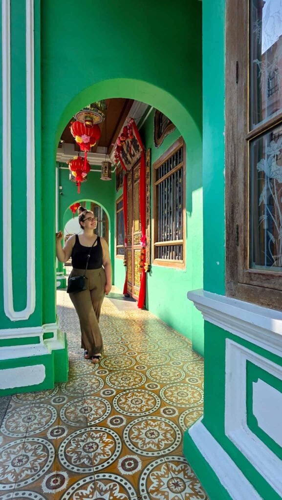 the author at the pinang peranakan mansion, an attraction on the penang travel itinerary